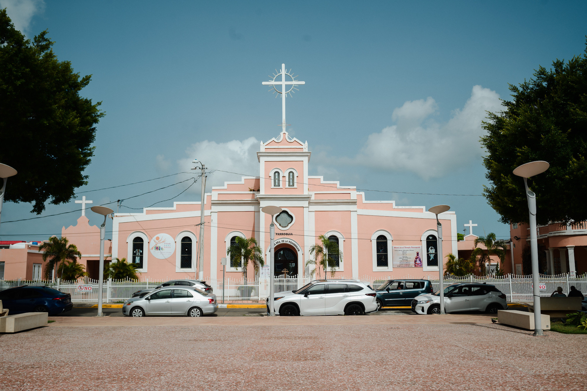 A large pink church under a blue sky