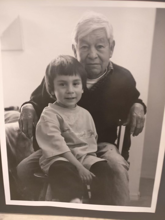 Johnny Juarez as a child sitting with his grandfather