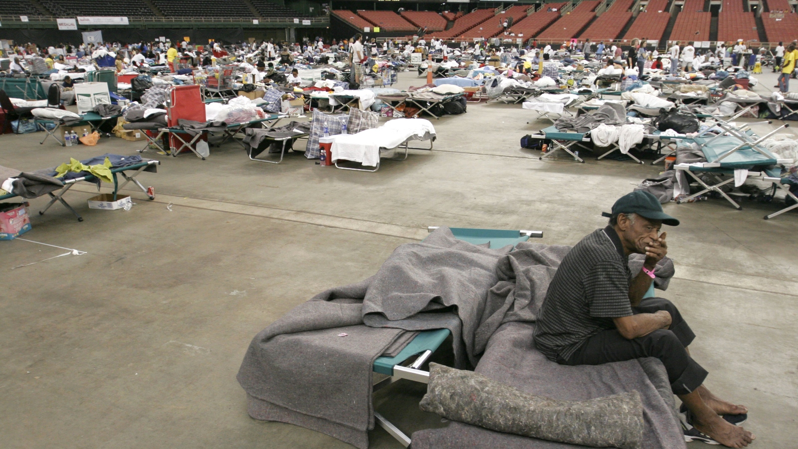 An evacuee from Hurricane Katrina sits on his cot while on the floor of the Reliant Astrodome September 7, 2005 in Houston, Texas.